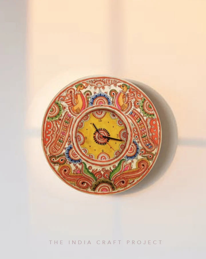 Peela Bageecha hand-painted Tholu wall clock featuring bright yellow floral designs, adding cheer to your space