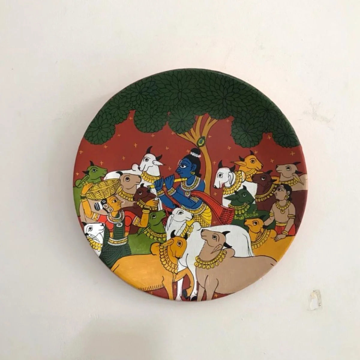 Vanshi Cheriyal hand-painted plate showcasing flute motifs with vibrant patterns in traditional artistry