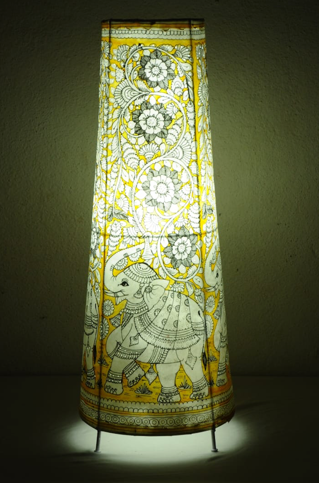 Gajraaj hand-painted Tholu tall corner lamp with intricate elephant designs, a striking artisan piece for ambient lighting